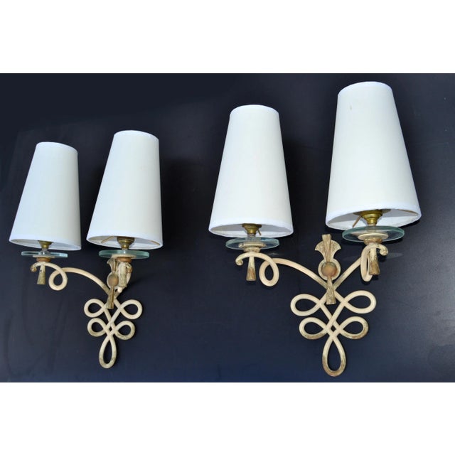 Superb pair of French Art Deco wrought iron with round Glass disc sconces, wall lights with beige and gold They come with...