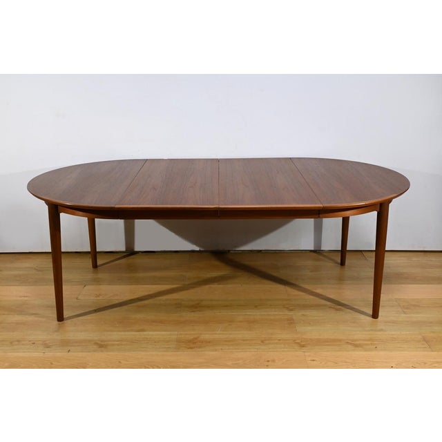 This Scandinavian teak dining table from the 1970s is a perfect example of clean, functional design. with its four spindle...