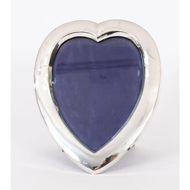 A charming antique Victorian heart shaped photo frame in sterling silver by Henry Matthews, Birmingham 1899. The heart...
