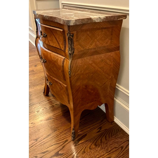 An exquisite Louis XV style bombé chest featuring exceptional craftsmanship and classic Rococo lines. The commode is...