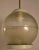 Spherical form Holophane shade hangs from brass tube. Capable of high wattage generating high light if desired. Metal cap,...
