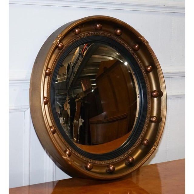 Antiques of London A striking circa 1920s Butler’s convex wall mirror, beautifully framed in gilt wood with a warm, time-...