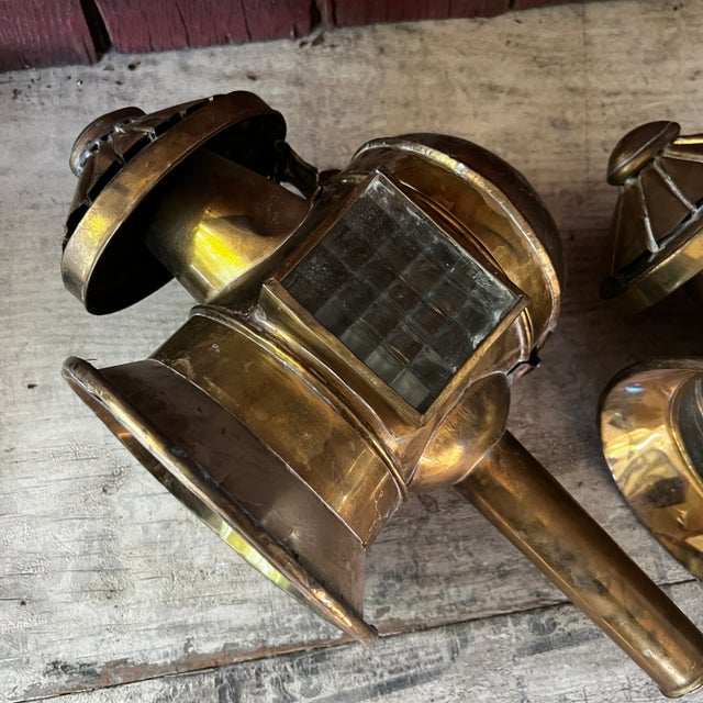These brass carriage lanterns, complete with glass panels and hinged doors, evoke historical charm. Ideal for home decor...