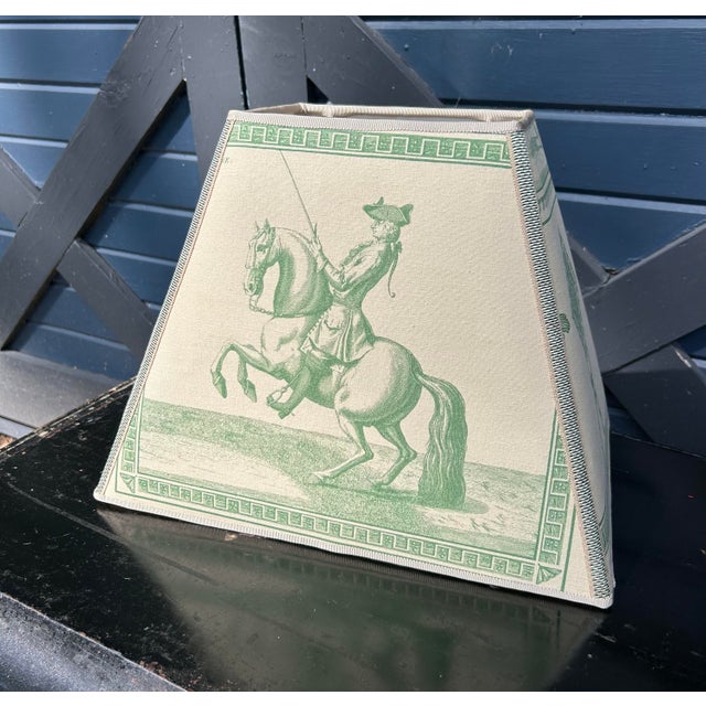 A lampshade handmade from an equestrian themed printed fabric. A washer top fitting