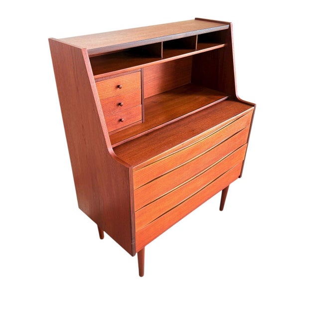 This beautifully crafted Danish teak vanity secretary desk, designed in the style of Arne Vodder, showcases the refined...