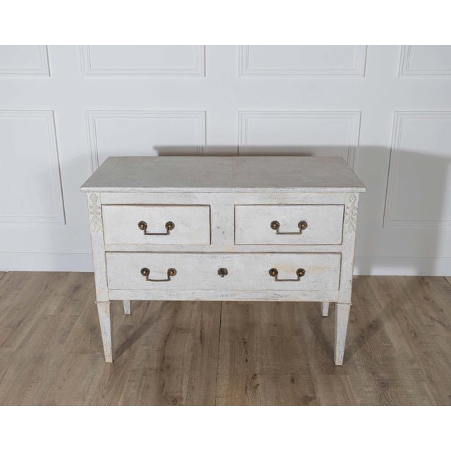 A charming French chest of drawers dating to circa 1920, beautifully painted in a light sand tone that complements its...