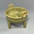 A vintage‑style Chinese Longquan celadon tripod censer, supported by three sturdy legs and fitted with two upright side...