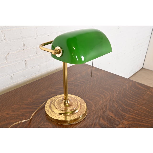 A gorgeous Art Deco banker's desk lamp USA, Circa Mid-20th Century Brass, with beautiful green glass shade. Measures:...