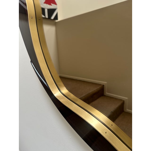This sleek round mirror features either in Macassar Ebony or lacquered frame. The exterior lines of the frame are a clean...
