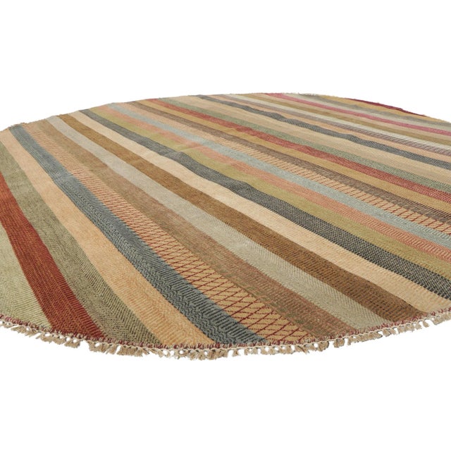 30300 Round Striped Area Rug 08'11 x 09'00.This hand-knotted wool round area rug features a striped pattern composed of...