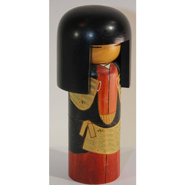 Kokeshi or Kokashi doll handmade by Japanese artisans from wood. The dolls have a simple trunk as a body and an enlarged...