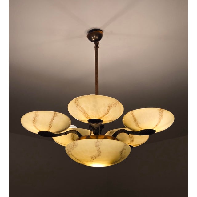 This stunning Art Deco chandelier is a true masterpiece of design and craftsmanship. Six individually marbled glass shades...