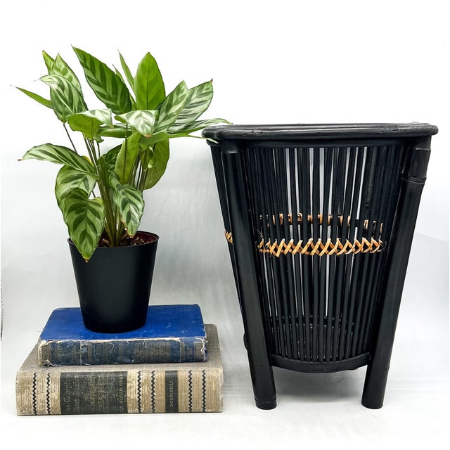 Vintage black bamboo wastebasket featuring a tall tapered form with slender bamboo slats, substantial bamboo supports, and...