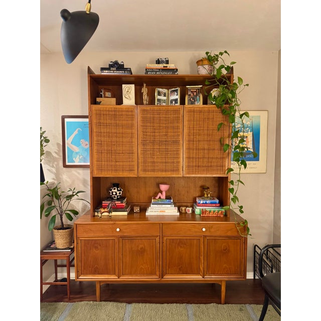 A beautiful mid century modern walnut and cane hutch designed by Kipp Stewart for Drexels “Declaration” line, circa 1960s....