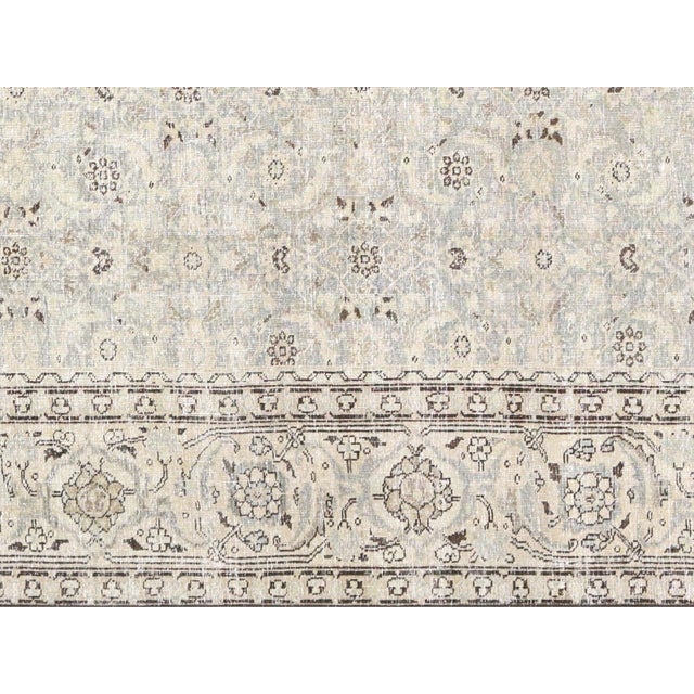 Enhance your home decor with this exquisite Antique Persian Tabriz Rug. Crafted from premium quality wool, this rug boasts...