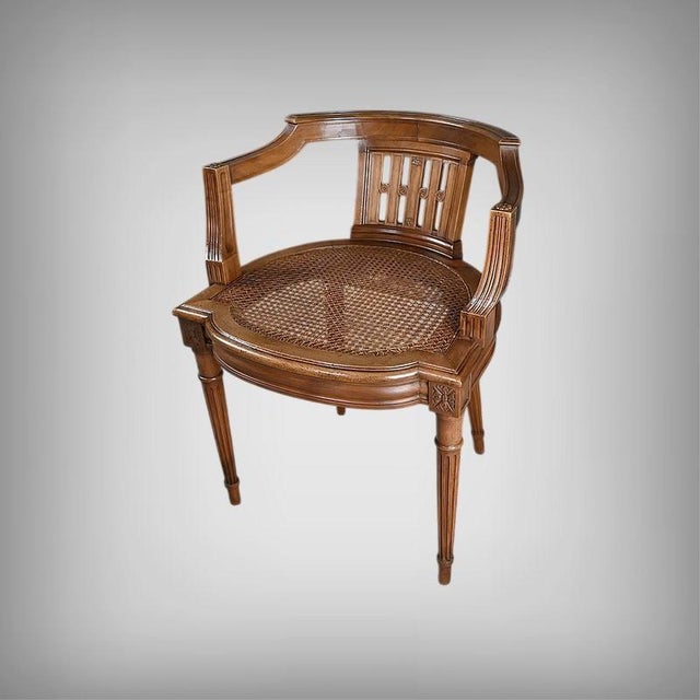 An elegant small office chair in carved walnut, in the louis xvi style, boasting a beautiful neoclassical structure: a...