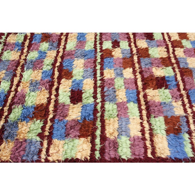 One-of-a-kind vintage hand-knotted Moroccan rug with plush organic wool pile. Exhibiting an intricate abstract display of...