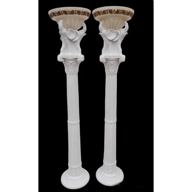 An incredible pair of monumental sized white gloss 3 elephant head pillar floor lamps. The lamps feature 3 elephant heads...