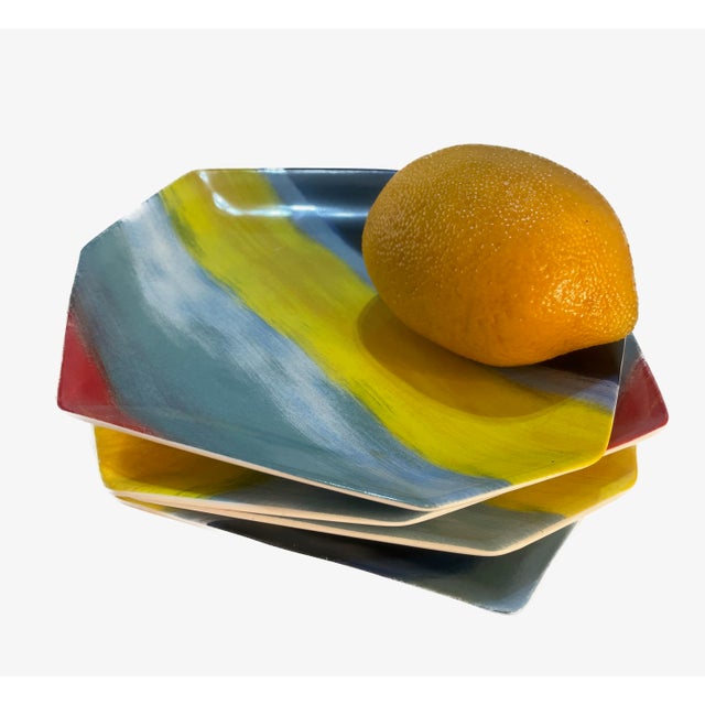 Add a bold, graphic punch to your tablescape with this vibrant set of four dessert or appetizer plates by iconic designer...