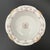 An antique Charles Ahrenfeldt soufflé dish in the AHR735 pattern, featuring a wreath motif at the center with pink rose...