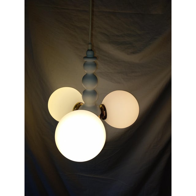 Manufacturer: The lamp is often identified as a work by Orion (Austria). Material: It features a white lacquered frame...