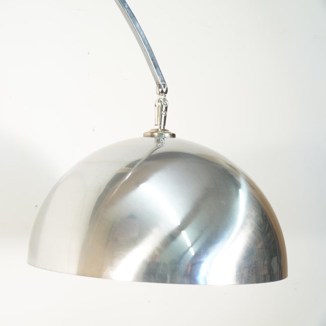 This is a larger scale Italian arc floor lamp, circa 1970s. It features a brushed aluminum shade and a chrome cantilever...