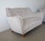 Two-seat button tufted sofa from circa 1952. Reupholstered in slightly shiny light beige/grey velvet. Lightly curved back....