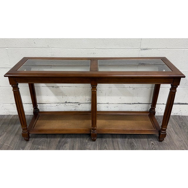 This is a beautiful vintage Mid Century Traditional walnut console table or hall table featuring two inset glass display...