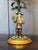 Each lamp with a polychrome cold painted bronze figure standing beside a palm tree — one depicting a male figure in hat...