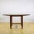 This imposing dining table, dating back to the early 1900s, is a masterful example of classic solid wood cabinetry. The...