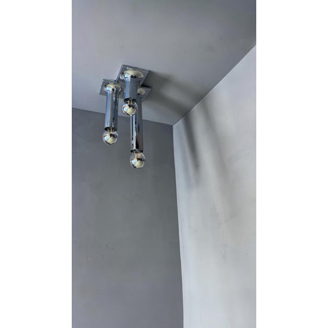An elegant set of three modernist ceiling lights in chromed metal, designed in the 1970s by German designer Rolf Krüger...