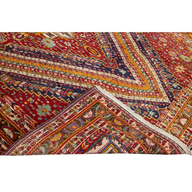 Beautiful Vintage Shiraz hand-knotted Wool rug with the red field. This Shiraz rug has a multicolor accents in all over...