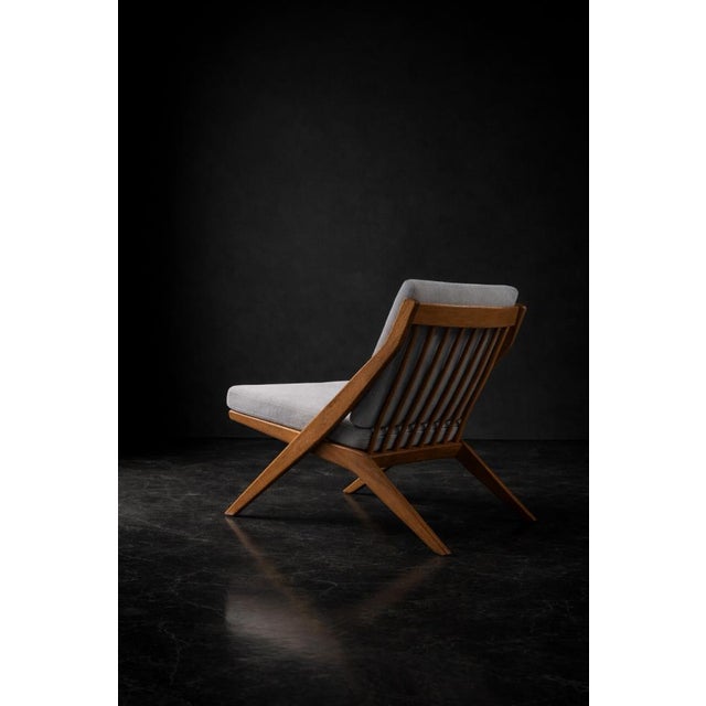 This scissors armchair set of two was designed by folke ohlsson for the swedish manufacturer bodafors in 1962. It has a...