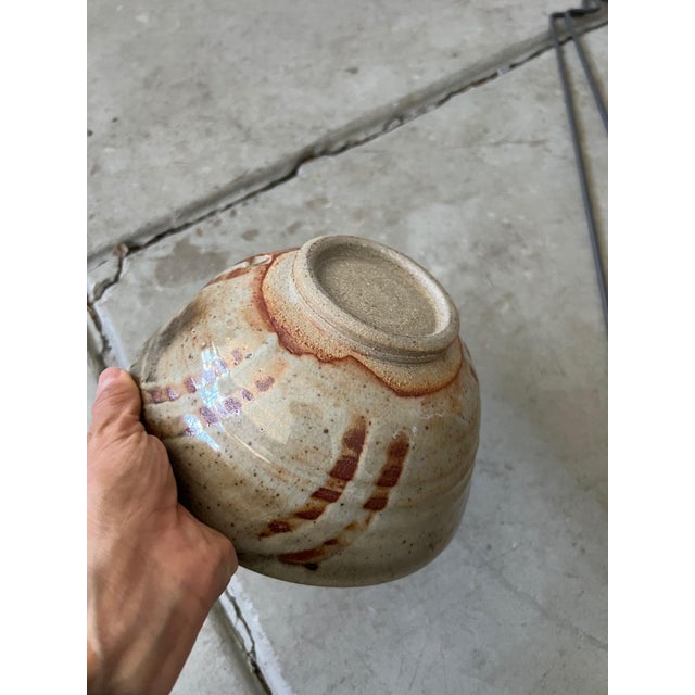 Set of 2 wood-fired shino studio pottery bowls with impressed potter's chop, late 20th century. Warm shino glaze, wood-ash...