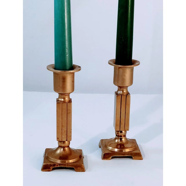 Solid brass mid-century pair of candlesticks with a squared off geometric design. Great patina on this pair of matching...