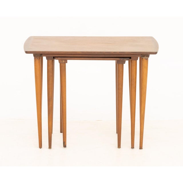 Set of Three Modern Walnut Nesting Tables, each on four tapered legs. Largest: 20" H x 26" W x 15" D. Provenance: The...