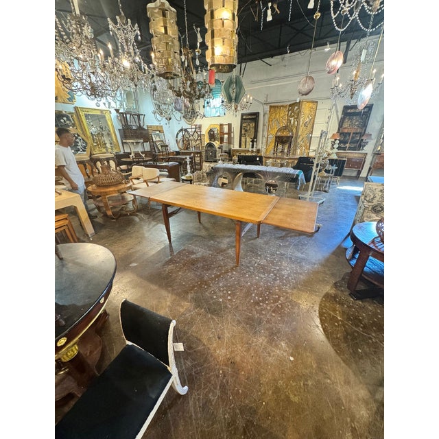 The Danish Mid Century Oak Dining Table is a stylish and functional piece of furniture for any home. Made from high-...