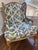 A French Provincial wingback bergère and matching ottoman by Baker Furniture. The ottoman bears Baker's original oval...