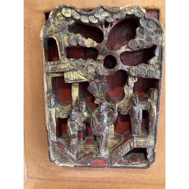 Very old rosewood carving of a botanical scene with people. Made of rosewood with gold gilding. Framed in brown suede with...