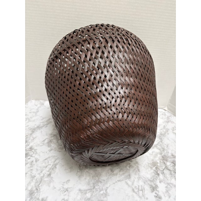 Large rustic elegant plant vessel or small tree planter with interior lining and dark chocolate brown woven wood exterior....