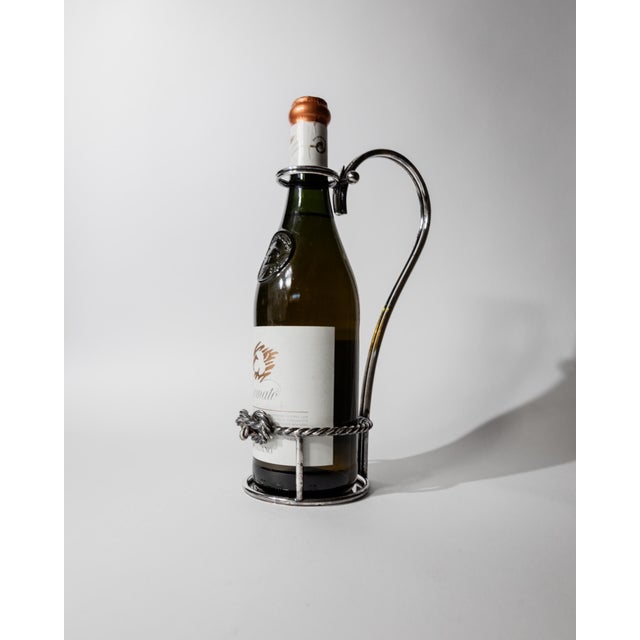 This vintage silver-plated wine bottle holder from the 1930s is an elegant and practical bar accessory, beautifully...