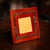 A 20th Century square picture frame in warm toned wood, accented with a brass band and distinctive buckle detail. Made in...