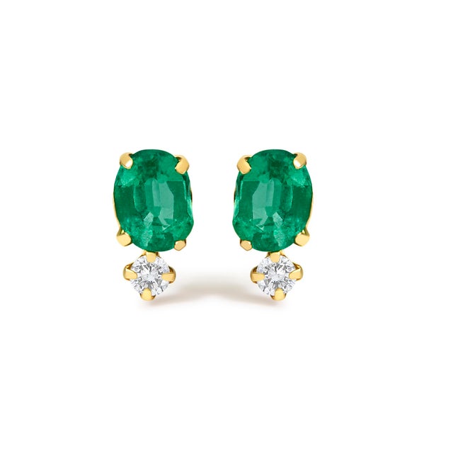 Glimmering in polished 18K yellow gold, these luminous double-drop studs marry verdant fire and airy sparkle in a sleek...