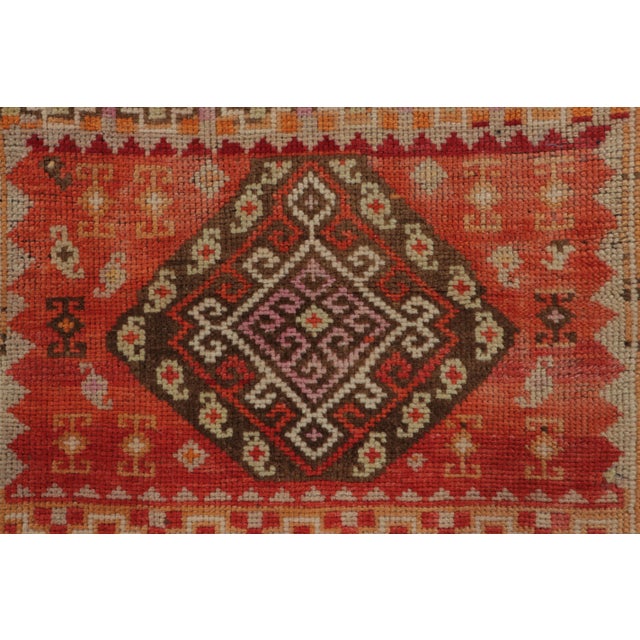 This gift-size 2x3 vintage Turkish rug, circa 1950–1959, features a striking geometric medallion framed by stepped borders...