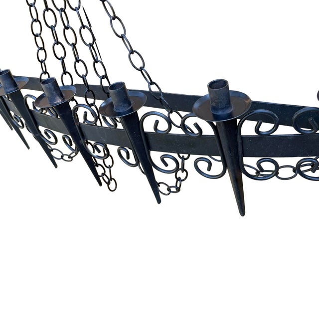 Vintage black wrought iron candelabra wall sconce. Adjustable chain height, holds 7 candles.