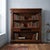 Open walnut bookcase, crafted in Italy in the first half of the 20th century. The structure features protruding columns,...