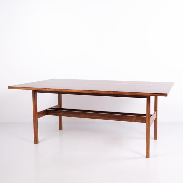 Danish design dining table from the 1960s, made of rosewood. The table features a rectangular tabletop and a simple design...