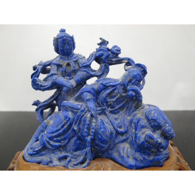 Chinese Lapis Lazuli carving of 2 figures and a creature. One figure stands while one lounges, maybe smoking a hookah....