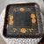 An antique, hand-painted, toleware tray. Yellow roses framed by a boarder of golden vines and petite blooms.