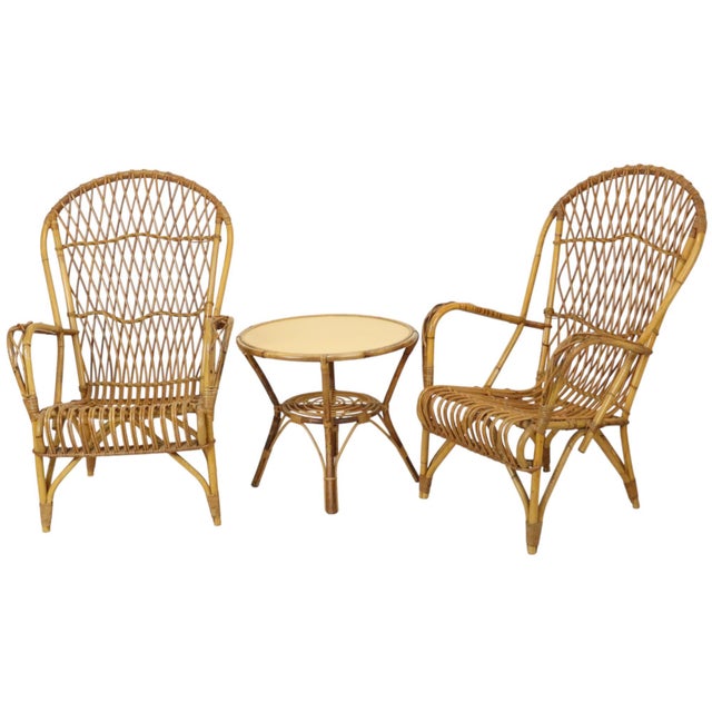 Very nice set of 2 rattan designer chairs or armchairs and a matching round rattan and wood side table, Boho style from...